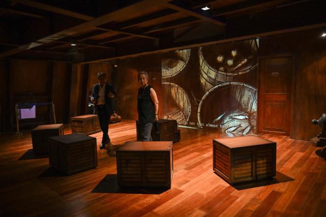 This photo taken on April 23, 2026 shows people visiting the Galeon Espiritu Santo, a full-scale representation of a 17th century galleon, on display at the Museo del Galeon in Manila. A full-size replica of a Spanish galleon stares out into Manila Bay, the centrepiece of a museum that will transport visitors back to the 17th century, when conscripted Philippine mariners birthed the era of globalisation. (Photo by Jam STA ROSA / AFP) / To go with AFP story Philippines-history-culture-Spain-shipping, FOCUS by Cecil MORELLA