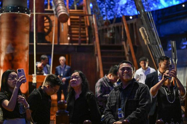 This photo taken on April 23, 2026 shows people visiting the Galeon Espiritu Santo, a full-scale representation of a 17th century galleon, on display at the Museo del Galeon in Manila. A full-size replica of a Spanish galleon stares out into Manila Bay, the centrepiece of a museum that will transport visitors back to the 17th century, when conscripted Philippine mariners birthed the era of globalisation. (Photo by Jam STA ROSA / AFP) / To go with AFP story Philippines-history-culture-Spain-shipping, FOCUS by Cecil MORELLA