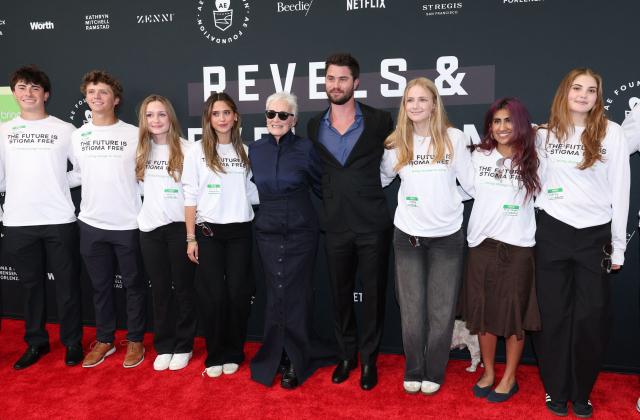 US actress Glenn Close and US actor Chase Stokes pose with volunteers as they attend non-profit organization Bring Change to Mind's "Revels and Revelations Celebration" at the Fort Mason Center for Arts and Culture in San Francisco, California, on April 27, 2026. (Photo by Christopher VICTORIO / AFP)