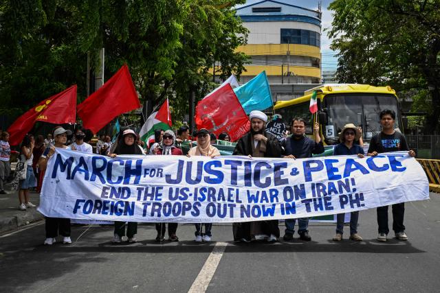 People take part in a protest against the US-Israel military actions in Iran, in Manila on April 28, 2026. (Photo by Jam STA ROSA / AFP)