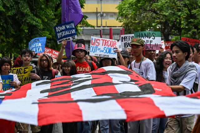 People take part in a protest against the US-Israel military actions in Iran, in Manila on April 28, 2026. (Photo by Jam STA ROSA / AFP)