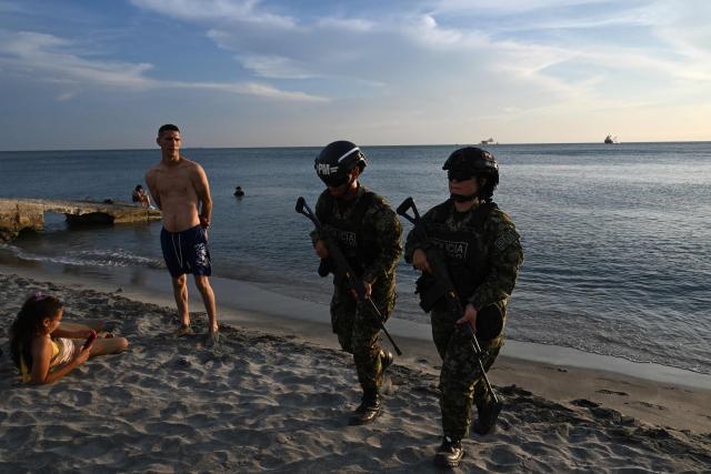Colombian soldiers patrol the Pozos Colorados Beach ahead of the International Conference on the Just Transition Away from Fossil Fuels in Santa Marta, Colombia, on April 27, 2026. (Photo by Raul ARBOLEDA / AFP)