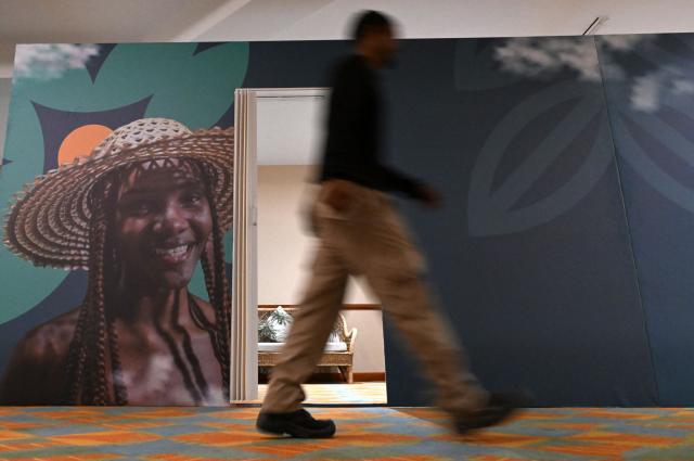 A worker walks on a hallway at the Estelar Convention Center during preparations ahead of the International Conference on the Just Transition Away from Fossil Fuels in Santa Marta, Colombia, on April 27, 2026. (Photo by Raul ARBOLEDA / AFP)