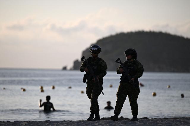 Colombian soldiers patrol the Pozos Colorados Beach ahead of the International Conference on the Just Transition Away from Fossil Fuels in Santa Marta, Colombia, on April 27, 2026. (Photo by Raul ARBOLEDA / AFP)