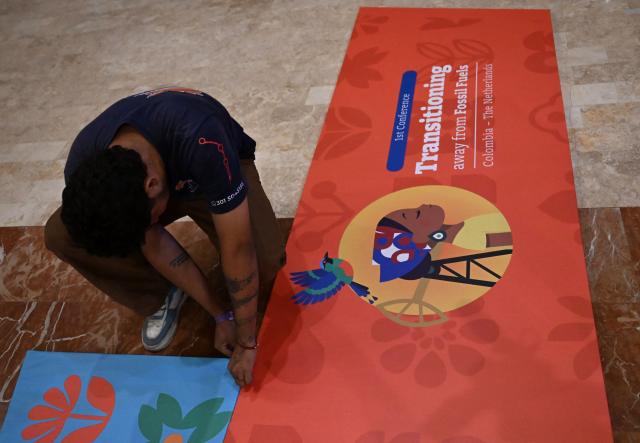 A worker prepares the venue at the Estelar Convention Center ahead of the International Conference on the Just Transition Away from Fossil Fuels in Santa Marta, Colombia, on April 27, 2026. (Photo by Raul ARBOLEDA / AFP)