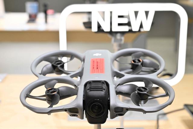A DJI Avata 360 model drone produced by company manufacturer DJI (Da-Jiang Innovators) is displayed at a mall in Beijing on April 28, 2026. On May 1, 2026 Beijing government will ban new consumer drone sales. (Photo by Adek BERRY / AFP)