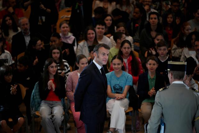 France's President and Co-Prince of Andorra Emmanuel Macron (C) speaks to students and teachers at Lycee Comte de Foix in Andorra la Vella, on the second day of his visit to the microstate of Andorra on April 28, 2026. (Photo by Ed JONES / POOL / AFP)