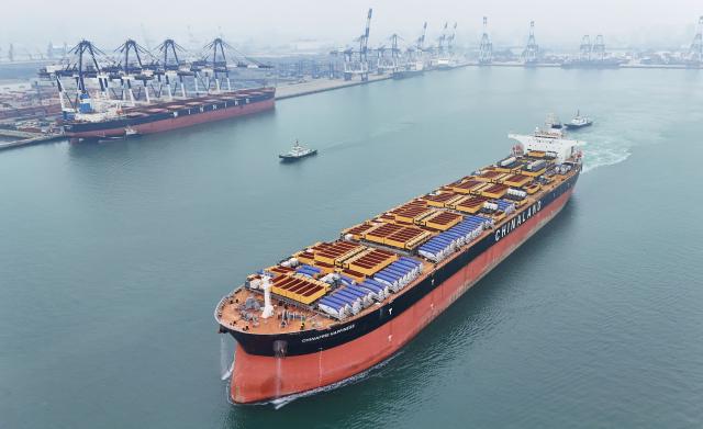 This aerial photo taken on April 27, 2026 shows a container ship carrying Chinese-made engineering vehicles sailing from Yantai Port to Nigeria in Yantai, in China's eastern Shandong Province. (Photo by CN-STR / AFP) / China OUT