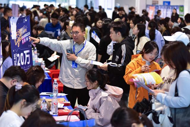 University students attend a job fair for graduates in Fuyang, in China's eastern Anhui Province on April 28, 2026. (Photo by CN-STR / AFP) / China OUT