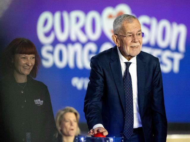 Austrian President Alexander Van Der Bellen (R) pushes the red button to start a light show during the official opening of the stage prior to the 70th Eurovision Song Contest (ESC) in Vienna, Austria on April 28, 2026. Vienna will host the two semi-finals of the ESC taking place on May 12 and May 14 and the final on May 16, 2026. (Photo by Joe Klamar / AFP)