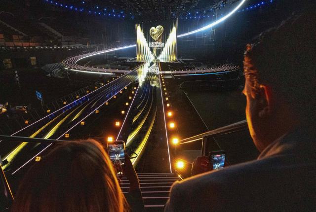 Guests take footage with their mobile phones of a light show during the official opening of the stage attended by Austrian President at the Wiener Stadthalle prior to the 70th Eurovision Song Contest (ESC), in Vienna, Austria on April 28, 2026. Vienna will host the two semi-finals of the ESC taking place on May 12 and May 14 and the final on May 16, 2026. (Photo by Joe Klamar / AFP)