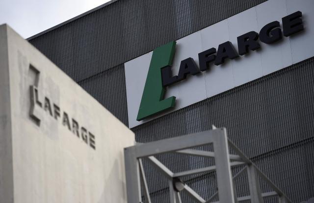 (FILES) A picture shows the logo on a plant of French cement company Lafarge on April 7, 2014 in Paris. French industrial company Lafarge, the world's largest cement manufacturer, along with all eight other defendants, including its former director Bruno Lafont, have appealed against their convictions for financing terrorism in Syria in 2013 and 2014, a Paris Court said on April 28, 2026. A French court on April 13 fined the cement group Lafarge over $1.3 million and sentenced its former boss to six years in prison for paying protection money to the Islamic State group and other jihadists to maintain its business in war-torn Syria. (Photo by FRANCK FIFE / AFP)