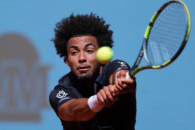 France’s Arthur Fils returns the ball to Argentina’s Tomas Martin Etcheverry during their 2026 ATP Tour Madrid Open tennis tournament singles match at the Caja Magica in Madrid, on April 28, 2026. (Photo by Thomas COEX / AFP)