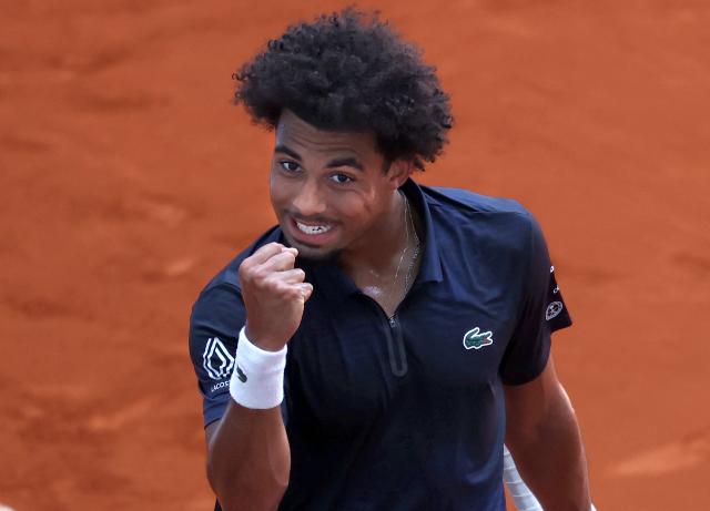 France’s Arthur Fils celebrates after winning a point against  Argentina’s Tomas Martin Etcheverry during their 2026 ATP Tour Madrid Open tennis tournament singles match at the Caja Magica in Madrid, on April 28, 2026. (Photo by Thomas COEX / AFP)