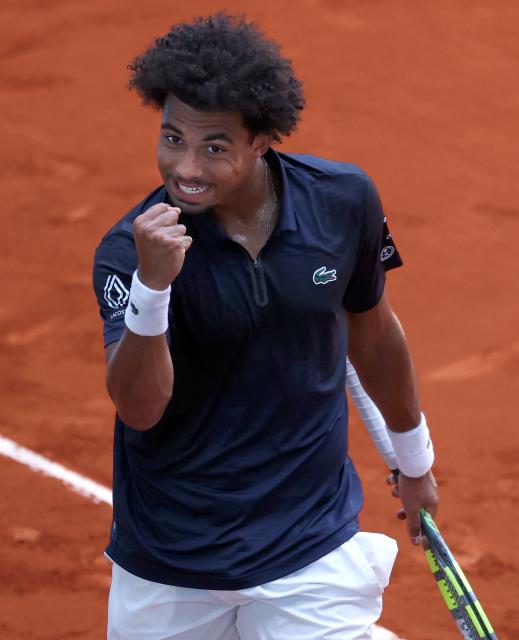 France’s Arthur Fils celebrates after winning a point against  Argentina’s Tomas Martin Etcheverry during their 2026 ATP Tour Madrid Open tennis tournament singles match at the Caja Magica in Madrid, on April 28, 2026. (Photo by Thomas COEX / AFP)