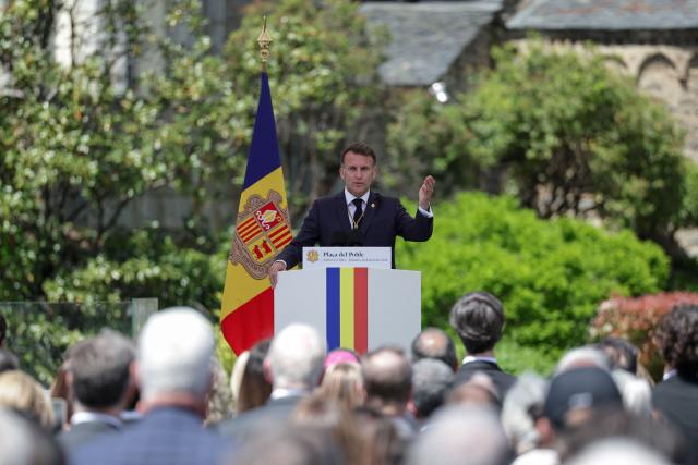 France's President and Co-Prince of Andorra Emmanuel Macron gestures as he delivers a speech at the Placa del Poble square in Andorra la Vella, on the second day of his visit to the microstate of Andorra on April 28, 2026. (Photo by Valentine CHAPUIS / POOL / AFP)