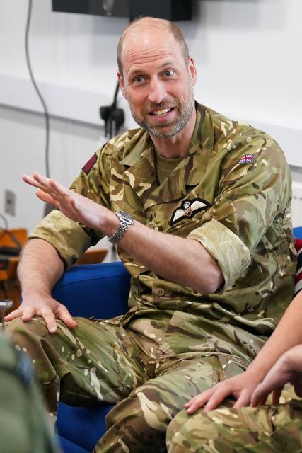 Britain's Prince William, Prince of Wales speaks with members of the female RAF team, which reflects his ongoing interest in the experience and welfare of women in the Armed Forces, during his visit to RAF Valley in Anglesey in north-west Wales on April 28, 2026, as part of celebrations marking its 85th anniversary. (Photo by Dominic Lipinski / POOL / AFP)