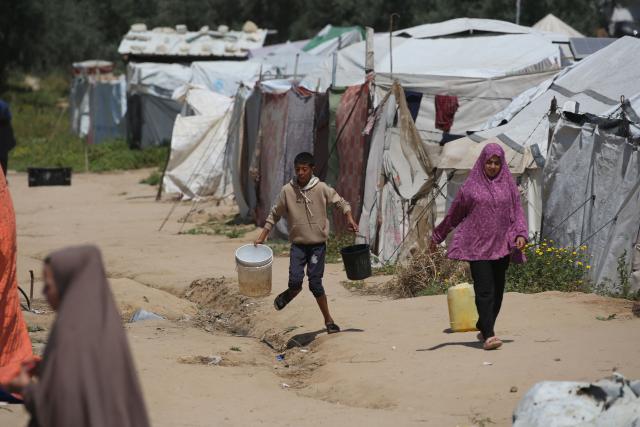 People fetch drinking water at the Bureij camp for Palestinian refugees in the central Gaza Strip on April 28, 2026. The majority of Gaza's 2.4 million people have been displaced, often multiple times, by the war that began with Hamas's attack on southern Israel on October 7, 2023. With displaced families living in tented camps, with serious concerns raised about their living conditions. (Photo by Eyad Baba / AFP)