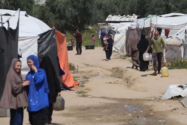 People fetch drinking water at the Bureij camp for Palestinian refugees in the central Gaza Strip on April 28, 2026. The majority of Gaza's 2.4 million people have been displaced, often multiple times, by the war that began with Hamas's attack on southern Israel on October 7, 2023. With displaced families living in tented camps, with serious concerns raised about their living conditions. (Photo by Eyad Baba / AFP)