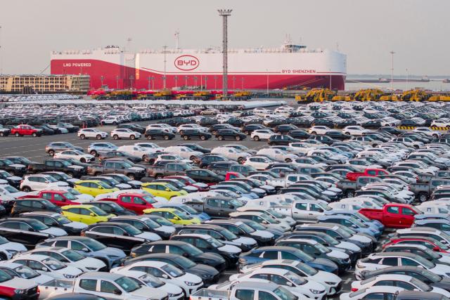 (FILES) The photo taken on April 27, 2025 shows BYD electric cars waiting to be loaded to the automobile carrier BYD "Shenzhen", which will sail to Brazil from the Taicang Port in Suzhou, in China’s eastern Jiangsu province. Chinese electric vehicle maker BYD recorded a 55 percent decline in first-quarter net profit, a Hong Kong stock filing showed on April 28, 2026, as weaker domestic demand added to pressure from cutthroat competition. (Photo by CN-STR / AFP) / China OUT
