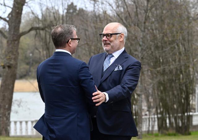 Estonia's President Alar Karis (R) is welcomed by Finland's Prime Minister Petteri Orpo during Karis' state visit to Finland, at the Prime Minister's official residence Kesaeranta in Helsinki, Finland on April 28, 2026. (Photo by Heikki Saukkomaa / Lehtikuva / AFP) / Finland OUT