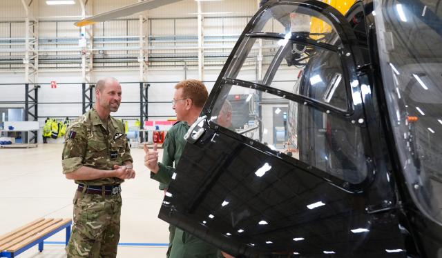 Britain's Prince William, Prince of Wales (L) speaks with members of the 202 Squadron during his visit to RAF Valley in Anglesey in north-west Wales on April 28, 2026, as part of celebrations marking its 85th anniversary. (Photo by Dominic Lipinski / POOL / AFP)