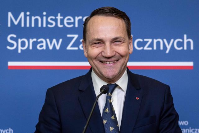 Polish Foreign Minister Radoslaw Sikorski smiles during press conference with the US President's Special Envoy for Belarus at the ministry building in Warsaw on April 28, 2026, after an exchange of prisoners. Poland on April 28 released a jailed Russian archaeologist, who was wanted by Ukraine, as part of a multi-country swap deal that also saw a Polish journalist freed from a Belarusian jail. (Photo by Wojtek RADWANSKI / AFP)