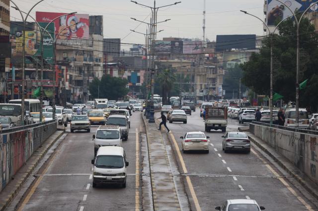 Vehicles are driven on the road following rainfall in Baghdad on April 28, 2026. Iraq has been experiencing heavy rainfall since the beginning of this year, leading to flooding. The country had been facing severe drought due to low rainfall and water cuts from upstream countries like Iran and Turkey. Dams and rivers are now overflowing as water returns after a prolonged dry spell. (Photo by AHMAD AL-RUBAYE / AFP)