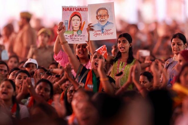 Women cheer as they arrive to attend India's Prime Minister Narendra Modi’s public meeting for women in Varanasi on April 28, 2026. (Photo by Niharika KULKARNI / AFP)