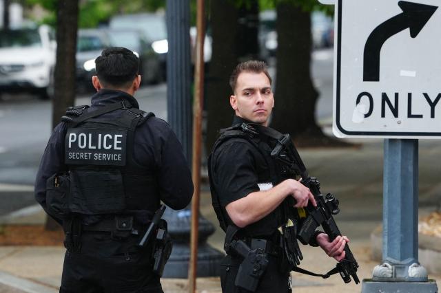 US Secret Service block a street near the White House before US President Donald Trump and First Lady Melania Trump greet Britain's King Charles III and Queen Camilla for an arrival ceremony on the South Lawn of the White House in Washington, DC, on April 28, 2026. (Photo by Aaron Schwartz / AFP)