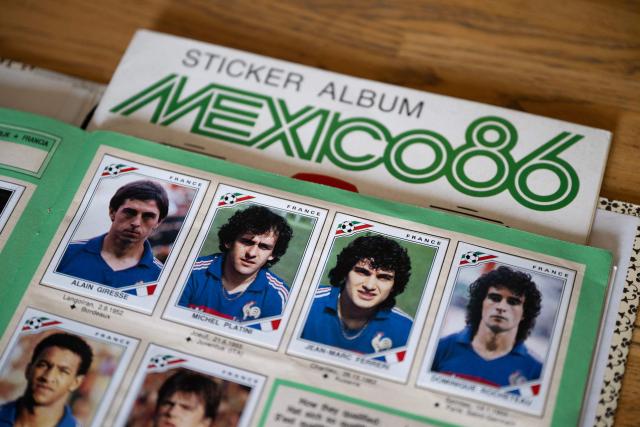 This picture shows (From L) French players Alain Giresse, Michel Platini, Jean-Marc Ferreri and Dominique Rocheteau on the Panini album from the Mexico 86 World Cup collection at the Panini Group factory in Modena, northern Italy, on April 28, 2026. The Panini Group holds the exclusive rights for the official collectible cards and stickers for the 2026 FIFA World Cup hosted by the US, Canada, and Mexico. (Photo by MARCO BERTORELLO / AFP)