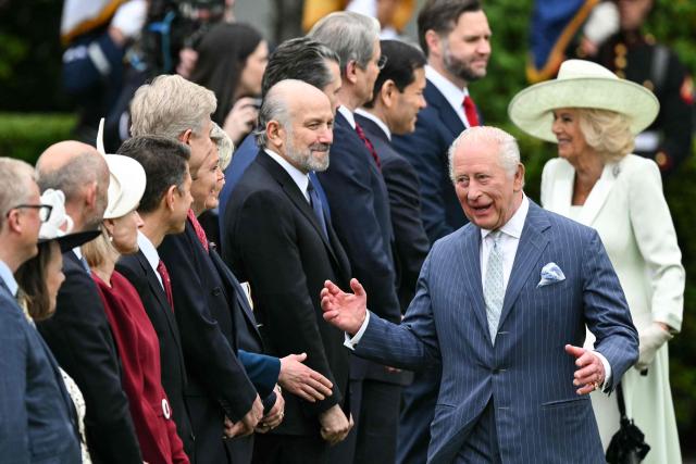 Britain's King Charles III and Queen Camilla greet cabinet members as they arrive for an arrival ceremony on the South Lawn of the White House in Washington, DC, on April 28, 2026. (Photo by Mandel NGAN / AFP)