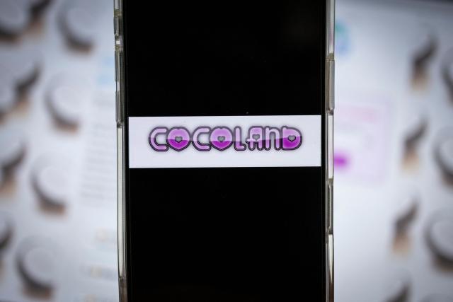 This photograph shows the logo of "Cocoland" website displayed on a smartphone in Paris on April 28, 2026. An investigation has been opened into the reappearance of the website Coco, now relaunched as Cocoland, with the cyber unit of the French gendarmerie tasked with the inquiry. The site, shut down in 2024 for facilitating sexual assaults and homophobic attacks, resurfaced with a new URL, sparking outrage from child protection groups. (Photo by Simon WOHLFAHRT / AFP)