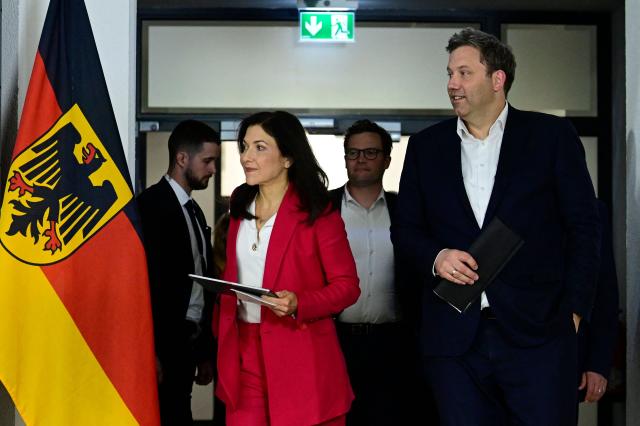 German Finance Minister and Vice Chancellor Lars Klingbeil (R) and German Economy and Energy Minister Katherina Reiche arrive for a press conference a round table meeting on strengthening German-Ukrainian cooperation in the security and defence industry at the Defence Ministry in Berlin on April 28, 2026. (Photo by John MACDOUGALL / AFP)