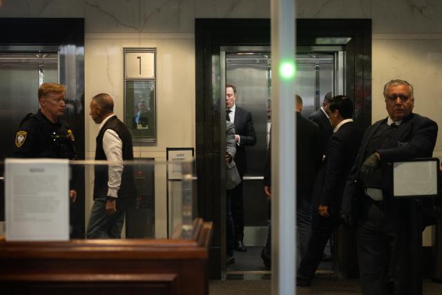 TOPSHOT - Elon Musk arrives at the federal courthouse as opening statements begin in the trial over Elon Musk's lawsuit against OpenAI in Oakland, California, on April 28, 2026. Opening remarks are set for April 28 in a courtroom showdown between billionaire Elon Musk and OpenAI over whether the artificial intelligence company betrayed its non-profit mission. The legal clash across the bay from San Francisco pits the world's richest person against a startup Musk once backed and now competes with in the booming AI sector. (Photo by Karl Mondon / AFP)