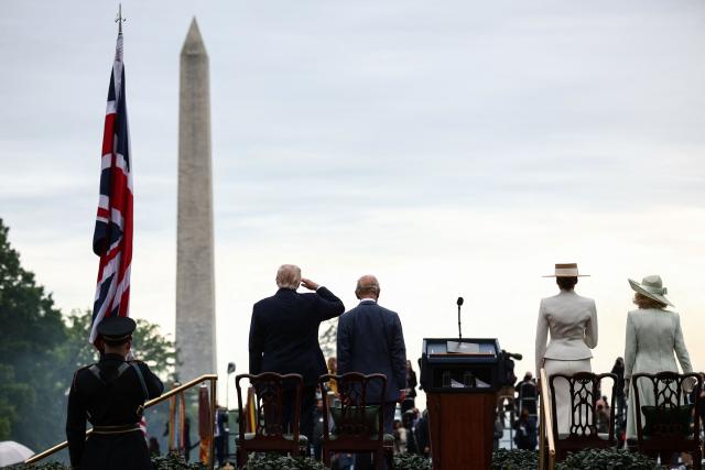 US President Donald Trump, First Lady Melania Trump, Britain's King Charles III and Queen Camilla take part in an arrival ceremony on the South Lawn of the White House in Washington, DC, on April 28, 2026. (Photo by HENRY NICHOLLS / POOL / AFP)