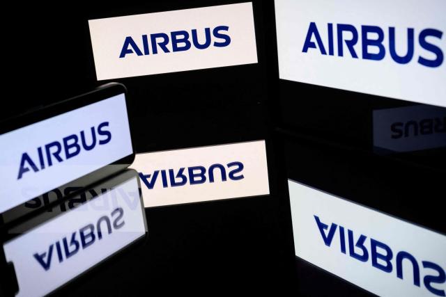 (FILES) This illustrative photograph shows screens displaying the logo of the French company Airbus, listed on the CAC 40, the main stock market index of the Paris Stock Exchange, in Toulouse on March 31, 2026. Airbus' low commercial aircraft deliveries, caused by a shortage of Pratt & Whitney engines, caused the European aircraft manufacturer’s net profit to fall by 26% to Ђ586 million in the first quarter, according to results published on April 28, 2026. (Photo by Lionel BONAVENTURE / AFP)