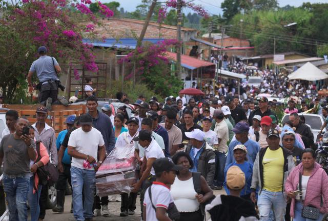 Mourners carry a coffin during the mass funeral for the victims of a highway bombing in Cajibio, Cauca department, Colombia on April 28, 2026. Colombia on April 27, 2026, was in mourning for the 21 victims of the country's deadliest bomb attack on civilians in decades, coming in the run-up to key elections. (Photo by Joaquin SARMIENTO / AFP)
