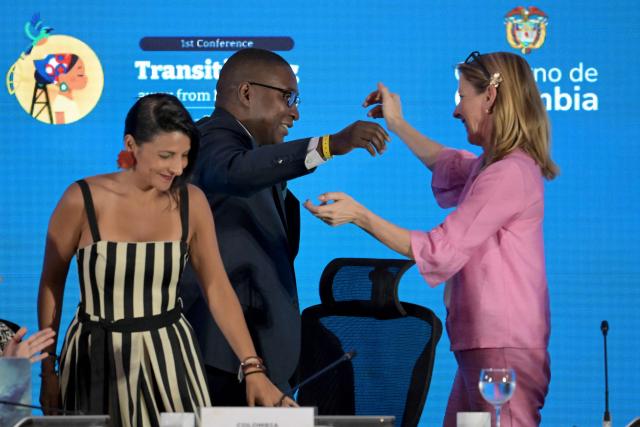 Selwin Hart (C), Special Adviser and Assistant Secretary-General for Climate Action at the United Nations, greets Dutch Minister for Climate and Green Growth Stientje van Veldhoven (R) alongside Colombia's Environment Minister Irene Velez during the International Conference on the Just Transition Away from Fossil Fuels in Santa Marta, Colombia, on April 28, 2026. (Photo by Raul ARBOLEDA / AFP)