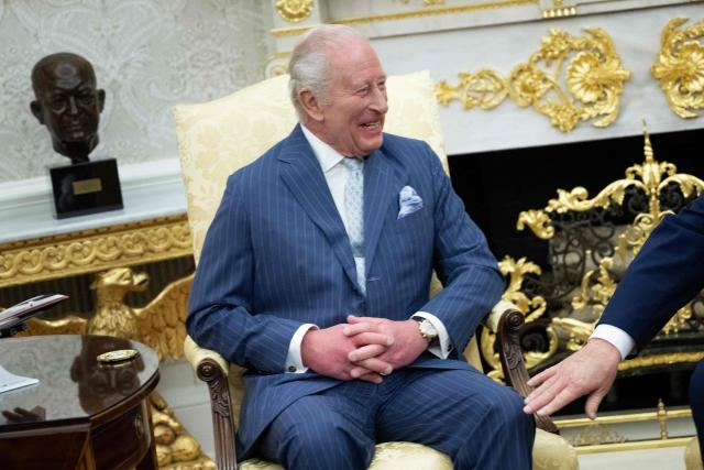 US President Donald Trump pats Britain's King Charles III on the leg during a meeting in the Oval Office of the White House April 28, 2026, in Washington, DC. (Photo by Brendan Smialowski / AFP)