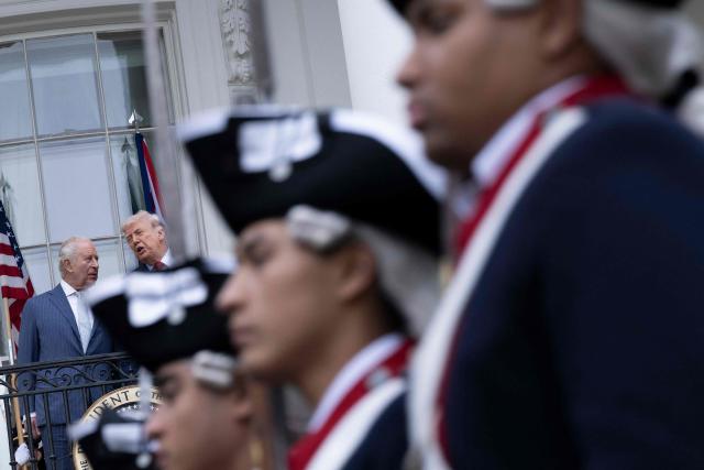 US President Donald Trump and Britain's King Charles III watch members of the Old Guard march by during a state arrival ceremony on the South Lawn of the White House on April 28, 2026 in Washington, DC. (Photo by Brendan Smialowski / AFP)
