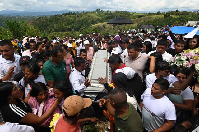 Mourners carry a coffin during the mass funeral for the victims of a highway bombing in Cajibio, Cauca department, Colombia on April 28, 2026. Colombia on April 27, 2026, was in mourning for the 21 victims of the country's deadliest bomb attack on civilians in decades, coming in the run-up to key elections. (Photo by JOAQUIN SARMIENTO / AFP)