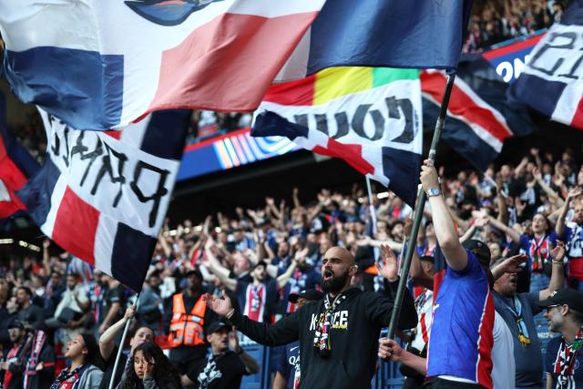 Paris Saint-Germain's supporters wave flags ahead of the UEFA Champions League semi-final first leg football match between Paris Saint-Germain (PSG) and Bayern Munich at the Parc des Princes in Paris on April 28, 2026. (Photo by FRANCK FIFE / AFP)