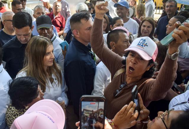 Colombia's right-wing presidential candidate Paloma Valencia (L) listens to a supporter shouting slogans during a campaign rally in Popayan, Cauca department, Colombia on April 28, 2026. Colombia will hold a presidential election on May 31, 2026. (Photo by Francisco Calderon / AFP)
