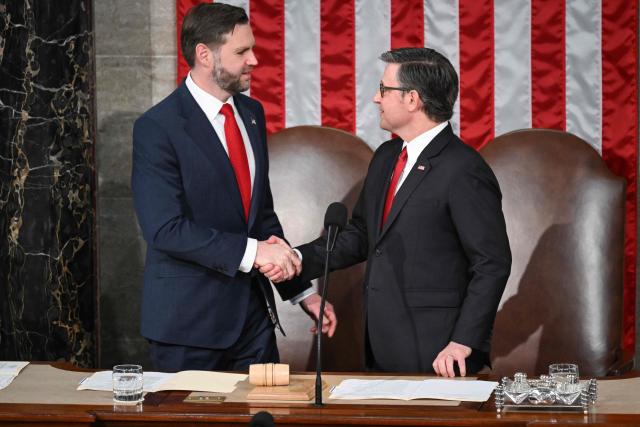 (L/R) US Vice President JD Vance shakes hands with Speaker of the House Mike Johnson before the arrival of Britain's King Charles III during a Joint Meeting of Congress in the House Chamber at the US Capitol in Washington, DC, on April 28, 2026. (Photo by SAUL LOEB / AFP)