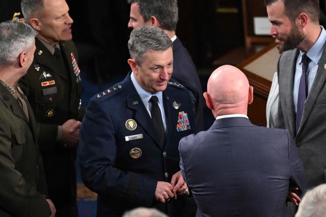 US Chairman of the Joint Chiefs of Staff General Dan Caine speaks with US Senator Mark Kelly, Democrat from Arizona, before the arrival of Britain's King Charles III during a Joint Meeting of Congress in the House Chamber at the US Capitol in Washington, DC, on April 28, 2026. (Photo by SAUL LOEB / AFP)