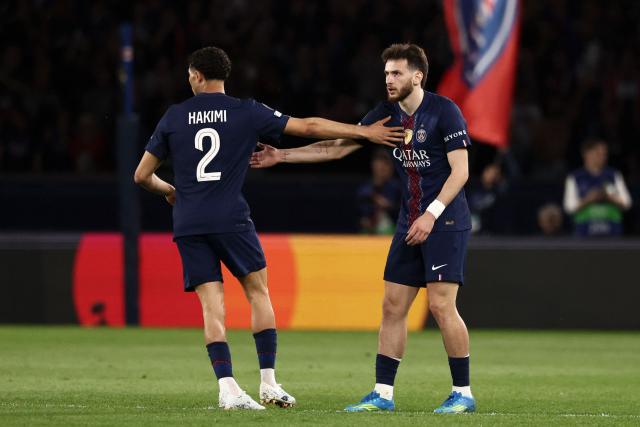 Paris Saint-Germain's Georgian forward #07 Khvicha Kvaratskhelia (R) celebrates with Paris Saint-Germain's Moroccan defender #02 Achraf Hakimi after scoring his team first goal during the UEFA Champions League semi-final first leg football match between Paris Saint-Germain (PSG) and Bayern Munich at the Parc des Princes in Paris on April 28, 2026. (Photo by FRANCK FIFE / AFP)