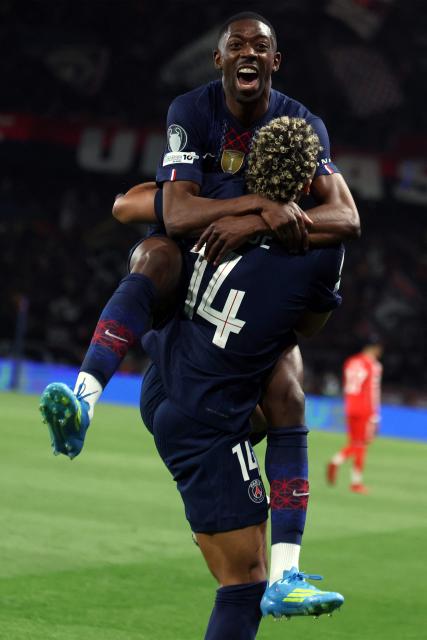 Paris Saint-Germain's French forward #10 Ousmane Dembele celebrates with Paris Saint-Germain's French midfielder #14 Desire Doue after scoring his team fifth goal during the UEFA Champions League semi-final first leg football match between Paris Saint-Germain (PSG) and Bayern Munich at the Parc des Princes in Paris on April 28, 2026. (Photo by ALAIN JOCARD / AFP)