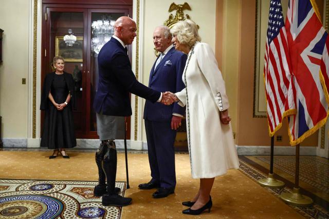 Britain's King Charles III and Queen Camilla are greeted by US Representative Brian Mast, Republican from Florida, before the King's address to a Joint Meeting of Congress in the House Chamber at the US Capitol in Washington, DC, on April 28, 2026. (Photo by Henry NICHOLLS / POOL / AFP)