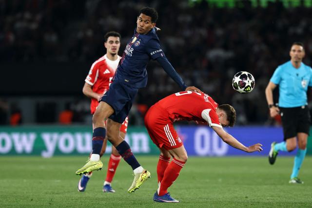 Paris Saint-Germain's French midfielder #24 Senny Mayulu (C) fights for the ball with Bayern Munich's German midfielder #06 Joshua Kimmich during the UEFA Champions League semi-final first leg football match between Paris Saint-Germain (PSG) and Bayern Munich at the Parc des Princes in Paris on April 28, 2026. (Photo by Anne-Christine POUJOULAT / AFP)